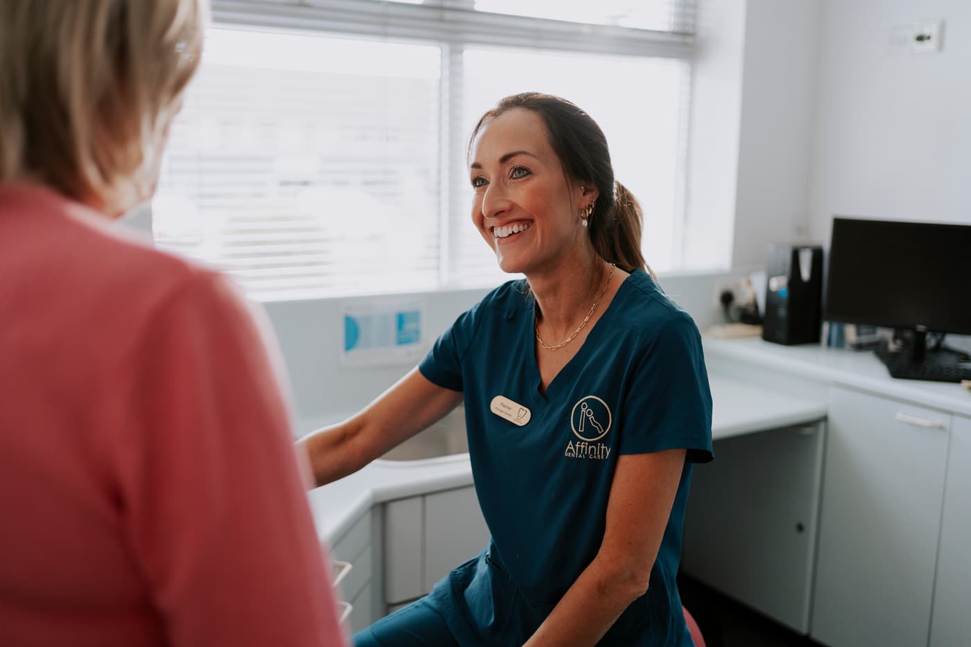 A dentist talking a patient through her options